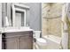Well-lit bathroom showcasing a shower-tub combo with tiled walls and dark vanity with white countertop at 12245 Marsh Pointe Rd, Sarasota, FL 34238