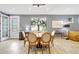 Dining room features a round table and light tile floors that connects to living room, kitchen and entry door at 12245 Marsh Pointe Rd, Sarasota, FL 34238