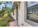 Inviting home entrance featuring a stylish front door, manicured landscaping, and a window with decorative trim at 12245 Marsh Pointe Rd, Sarasota, FL 34238