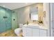 Stylish bathroom featuring a blue tiled shower, modern vanity, and natural light at 1354 Westway Dr, Sarasota, FL 34236