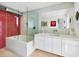 Modern bathroom with a red tiled shower, soaking tub, and sleek vanity at 1354 Westway Dr, Sarasota, FL 34236