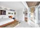 Bright bedroom with white walls, marble floors, and access to a hallway at 1354 Westway Dr, Sarasota, FL 34236