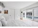 Airy bedroom showcasing pool view through expansive glass doors and white tile floors at 1354 Westway Dr, Sarasota, FL 34236