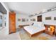 Bright bedroom featuring hardwood furniture, crisp white bedding, and curated artwork at 1354 Westway Dr, Sarasota, FL 34236