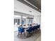 Bright dining room with contemporary lighting, seating for ten, and access to the outdoor patio at 1354 Westway Dr, Sarasota, FL 34236