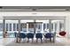 Stylish dining room with modern blue chairs, views of the pool, and access to outdoor areas at 1354 Westway Dr, Sarasota, FL 34236