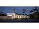 Stunning exterior view of a modern home at night, showcasing its sleek design and manicured landscaping at 1354 Westway Dr, Sarasota, FL 34236