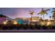 Modern home featuring unique architectural design, lush landscaping, and artistic details, all beautifully lit at 1354 Westway Dr, Sarasota, FL 34236