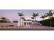 Modern home exterior featuring sleek lines, minimalist landscaping, and striking palm trees at twilight at 1354 Westway Dr, Sarasota, FL 34236