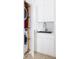 Compact laundry with stacked washer and dryer hidden behind white cabinets at 1354 Westway Dr, Sarasota, FL 34236