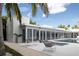 Expansive outdoor patio with modern seating, lush foliage, and views of the swimming pool at 1354 Westway Dr, Sarasota, FL 34236