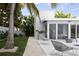 Modern patio with seating, tropical foliage, and seamless indoor-outdoor flow to the main residence at 1354 Westway Dr, Sarasota, FL 34236