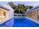 Inviting pool surrounded by contemporary architecture and lush landscaping, creating a private backyard oasis at 1354 Westway Dr, Sarasota, FL 34236