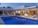 Expansive pool area with sleek lounge seating and seamless transition to indoor living spaces via large glass doors at 1354 Westway Dr, Sarasota, FL 34236