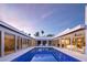 Stunning lap pool surrounded by a modern home with glass walls and inviting outdoor seating at 1354 Westway Dr, Sarasota, FL 34236