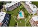 Aerial view of condo buildings with a swimming pool and manicured grounds offering resort-style amenities at 1485 Gulf Of Mexico Dr # 205, Longboat Key, FL 34228