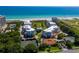 Stunning aerial view showcases condo buildings, pristine beach access, and community pool, perfect for relaxation at 1485 Gulf Of Mexico Dr # 205, Longboat Key, FL 34228