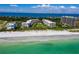 Stunning aerial view of beachfront condos with turquoise waters and pristine sandy beaches, a luxurious coastal retreat at 1485 Gulf Of Mexico Dr # 205, Longboat Key, FL 34228