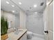Bathroom features a neutral color palette with a tiled shower, modern sink, and updated fixtures at 1485 Gulf Of Mexico Dr # 205, Longboat Key, FL 34228