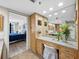 Bathroom with vanity, granite countertops and access to bedroom with blue comforter at 1485 Gulf Of Mexico Dr # 205, Longboat Key, FL 34228