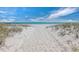 Sandy path leads to a beautiful beach with ocean views and calming dunes at 1485 Gulf Of Mexico Dr # 205, Longboat Key, FL 34228