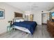 Bright bedroom with a blue comforter, stylish decor, and light wood flooring at 1485 Gulf Of Mexico Dr # 205, Longboat Key, FL 34228