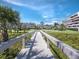 Inviting walkway bridge leading to pristine residences with lush greenery and manicured lawns at 1485 Gulf Of Mexico Dr # 205, Longboat Key, FL 34228