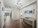 Inviting foyer with tile flooring and chandelier, offering a glimpse into the living spaces at 1485 Gulf Of Mexico Dr # 205, Longboat Key, FL 34228