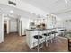 Modern kitchen with white cabinets, black countertops, stainless steel appliances, and bar seating, with tile floors at 1485 Gulf Of Mexico Dr # 205, Longboat Key, FL 34228