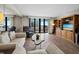 Cozy living room features comfortable sofas and scenic views from the sliding glass doors at 1485 Gulf Of Mexico Dr # 205, Longboat Key, FL 34228