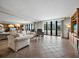 Bright living room with comfortable seating and sliding glass doors that open to a balcony at 1485 Gulf Of Mexico Dr # 205, Longboat Key, FL 34228