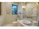 Powder bathroom featuring marble countertop, a unique sink, and stylish fixtures at 16010 Topsail Terrace, Lakewood Ranch, FL 34202