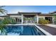 Inviting pool area with clear blue water and modern outdoor kitchen in the background at 16010 Topsail Terrace, Lakewood Ranch, FL 34202