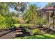 Manicured backyard landscaping leading toward enclosed pool at 1610 S Lake Shore Dr, Sarasota, FL 34231