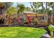Landscaped backyard with a wooden bench and manicured lawn at 1610 S Lake Shore Dr, Sarasota, FL 34231