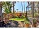 Lush backyard landscaping and hardscaping as viewed from the enclosed pool area at 1610 S Lake Shore Dr, Sarasota, FL 34231