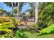 Backyard with landscaped garden area and hot tub at 1610 S Lake Shore Dr, Sarasota, FL 34231
