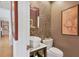 Elegant powder room featuring a vessel sink, mosaic wall, and decorative artwork at 1610 S Lake Shore Dr, Sarasota, FL 34231