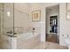Elegant bathroom with a soaking tub, glass-enclosed shower, and access to an organized walk-in closet at 1610 S Lake Shore Dr, Sarasota, FL 34231