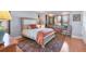 Comfortable bedroom featuring hardwood floors, a cozy bed, and an adjacent office nook near a window at 1610 S Lake Shore Dr, Sarasota, FL 34231