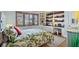 Inviting bedroom with a desk area and built-in bookshelves and ample natural light at 1610 S Lake Shore Dr, Sarasota, FL 34231