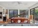 Bright dining area with wood table and chairs and backyard view at 1610 S Lake Shore Dr, Sarasota, FL 34231