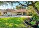 Charming single-story home boasts a neatly manicured lawn, tile roof, and a welcoming front entrance at 1610 S Lake Shore Dr, Sarasota, FL 34231