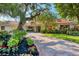 Single-story home with mature landscaping around the property at 1610 S Lake Shore Dr, Sarasota, FL 34231