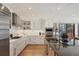 Bright kitchen with stainless appliances, white cabinetry and large center island at 1610 S Lake Shore Dr, Sarasota, FL 34231