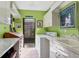 Functional laundry room with bright green walls and ample counter space at 1610 S Lake Shore Dr, Sarasota, FL 34231