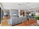 Spacious living room with an open floor plan, light wood floors, and a comfortable gray sectional at 1610 S Lake Shore Dr, Sarasota, FL 34231