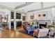 Living room view with hardwood floors, fireplace, and wet bar at 1610 S Lake Shore Dr, Sarasota, FL 34231
