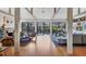 Open-concept living room with vaulted ceilings, hardwood floors, and access to outdoor pool at 1610 S Lake Shore Dr, Sarasota, FL 34231