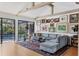 Bright living room featuring a comfortable sectional sofa, hardwood floors, and a view of the pool at 1610 S Lake Shore Dr, Sarasota, FL 34231